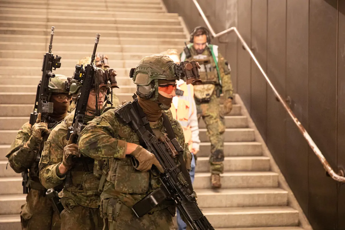German-soldiers-from-the-Wachbataillon-took-part-in-the-nighttime-Bollwerk-Baerlin-III-exercise-at-Jungfernheide-U-Bahn-station-in-Berlin-on-Wednesday-November-19-2025-The-large-scale-drill-trained-troops-to-fight-in-confined-underground-spaces-clear-subway-cars-evacuate-casualties-and-respond-to-simulated-saboteur-attacks-The-Bundeswehr-says-the-exercise-reflects-Germany-s-renewed-focus-on-national-and-alliance-defense-amid-rising-security-tensions-in-Europe-following-Russia-s-war-against-Ukraine-The-unit-best-known-for-its-ceremonial-duties-is-expanding-its-infantry-capabilities-to-protect-federal-government-infrastructure-in-a-crisis