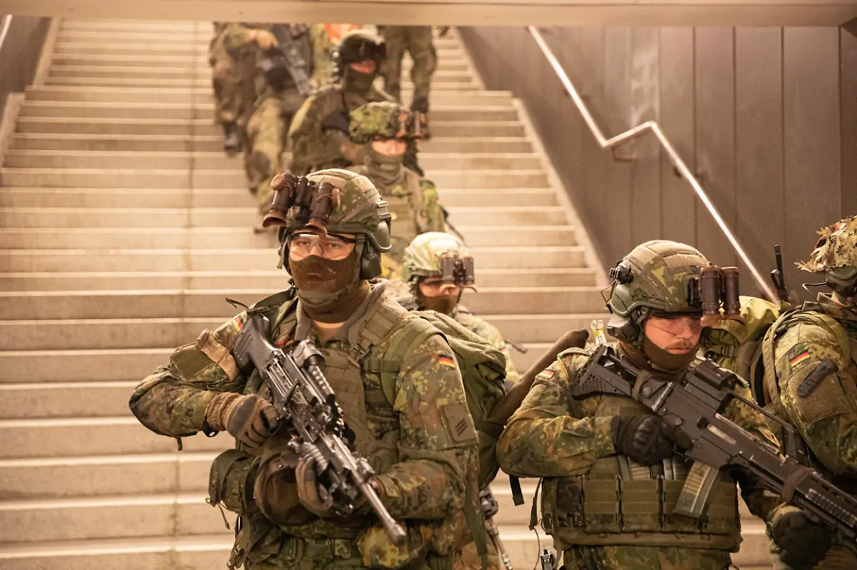 German-soldiers-from-the-Wachbataillon-took-part-in-the-nighttime-Bollwerk-Baerlin-III-exercise-at-Jungfernheide-U-Bahn-station-in-Berlin-on-Wednesday-November-19-2025-The-large-scale-drill-trained-troops-to-fight-in-confined-underground-spaces-clear-subway-cars-evacuate-casualties-and-respond-to-simulated-saboteur-attacks-The-Bundeswehr-says-the-exercise-reflects-Germany-s-renewed-focus-on-national-and-alliance-defense-amid-rising-security-tensions-in-Europe-following-Russia-s-war-against-Ukraine-The-unit-best-known-for-its-ceremonial-duties-is-expanding-its-infantry-capabilities-to-protect-federal-government-infrastructure-in-a-crisis