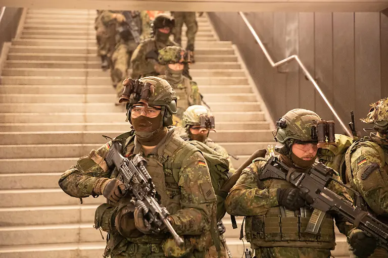 German-soldiers-from-the-Wachbataillon-took-part-in-the-nighttime-Bollwerk-Baerlin-III-exercise-at-Jungfernheide-U-Bahn-station-in-Berlin-on-Wednesday-November-19-2025-The-large-scale-drill-trained-troops-to-fight-in-confined-underground-spaces-clear-subway-cars-evacuate-casualties-and-respond-to-simulated-saboteur-attacks-The-Bundeswehr-says-the-exercise-reflects-Germany-s-renewed-focus-on-national-and-alliance-defense-amid-rising-security-tensions-in-Europe-following-Russia-s-war-against-Ukraine-The-unit-best-known-for-its-ceremonial-duties-is-expanding-its-infantry-capabilities-to-protect-federal-government-infrastructure-in-a-crisis