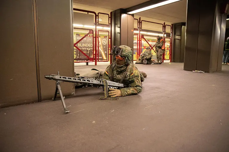 German-soldiers-from-the-Wachbataillon-took-part-in-the-nighttime-Bollwerk-Baerlin-III-exercise-at-Jungfernheide-U-Bahn-station-in-Berlin-on-Wednesday-November-19-2025-The-large-scale-drill-trained-troops-to-fight-in-confined-underground-spaces-clear-subway-cars-evacuate-casualties-and-respond-to-simulated-saboteur-attacks-The-Bundeswehr-says-the-exercise-reflects-Germany-s-renewed-focus-on-national-and-alliance-defense-amid-rising-security-tensions-in-Europe-following-Russia-s-war-against-Ukraine-The-unit-best-known-for-its-ceremonial-duties-is-expanding-its-infantry-capabilities-to-protect-federal-government-infrastructure-in-a-crisis
