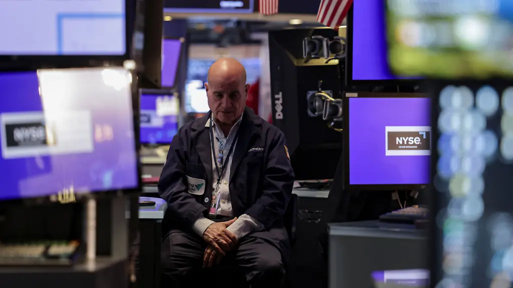 A-trader-works-on-the-floor-at-the-New-York-Stock-Exchange-NYSE-in-New-York-City-U-S-November-14-2025