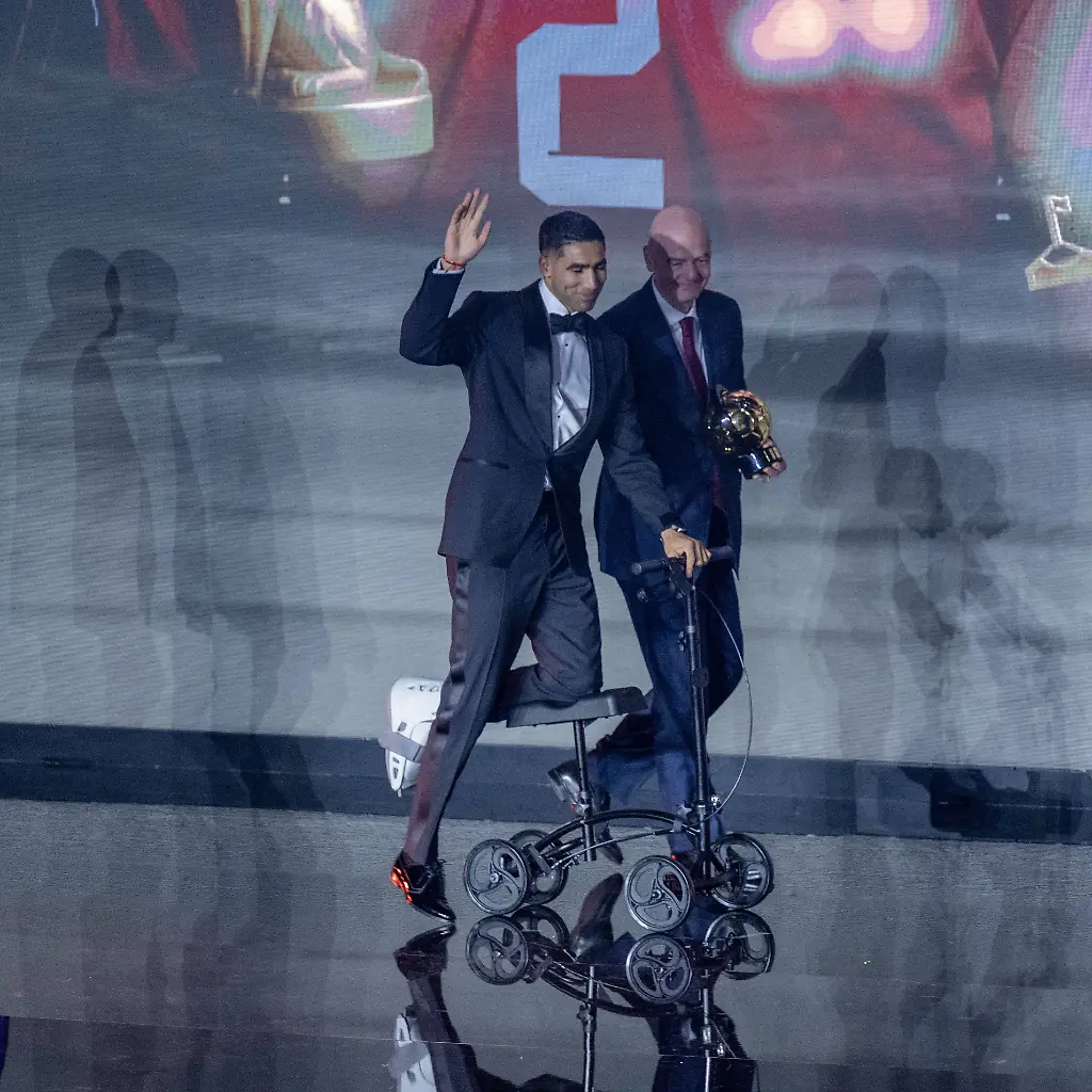 CAF-Awards-2025-SALE-MOROCCO-NOVEMBER-19-Paris-Saint-Germains-Moroccan-player-Achraf-Hakimi-C-receives-the-African-Footballer-of-the-Year-award-during-the-CAF-Awards-ceremony-in-Sale-Morocco-on-November-19-2025-FIFA-President-Gianni-Infantino-R-and-Confederation-of-African-Football-CAF-President-Patrice-Motsepe-L-attended-the-event-Abu-Adem-Muhammed-Anadolu-Sale-Morocco-Editorial-use-only-Please-get-in-touch-for-any-other-usage
