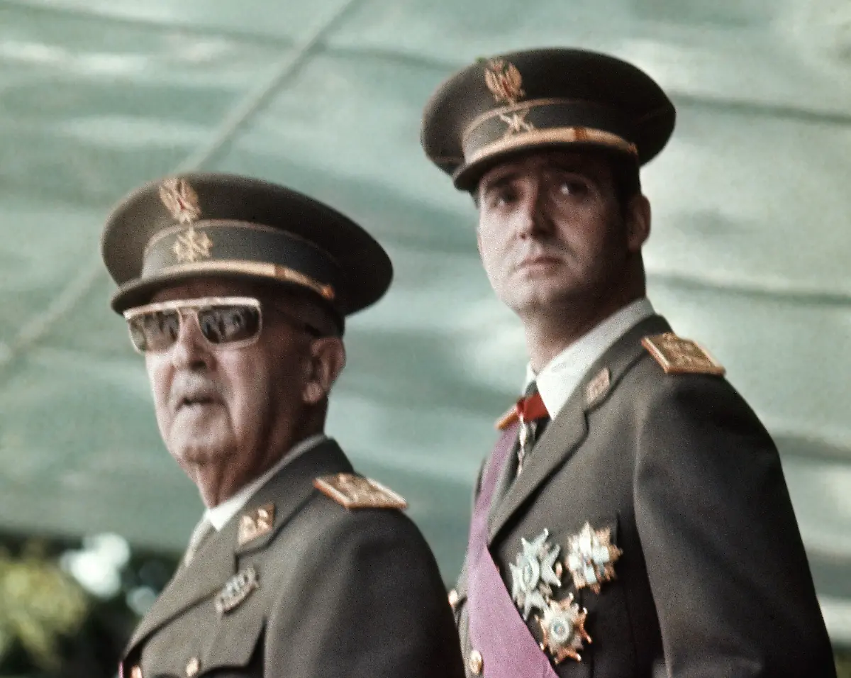FILE-This-is-a-May-1973-file-photo-of-Spain-s-leader-Francisco-Franco-left-with-his-future-successor-as-King-Prince-Juan-Carlos-de-Borbon-as-they-watch-a-military-parade-in-Madrid-Spain-s-King-Juan-Carlos-will-abdicate-and-pave-the-way-for-his-son-Crown-Prince-Felipe-to-take-over-Spanish-Prime-Minister-Mariano-Rajoy-told-the-country-Monday-in-an-announcement-broadcast-nationwide-He-did-not-say-when-Juan-Carlos-would-abdicate-because-the-government-must-now-craft-a-law-creating-a-legal-mechanism-for-the-abdication-and-for-46-year-old-Felipe-s-assumption-of-power-King-Juan-Carlos-came-to-power-in-1975-two-days-after-the-death-of-longtime-dictator-Francisco-Franco-He-endeared-himself-to-many-Spaniards-in-large-part-by-putting-down-an-attempted-military-coup-in-1981-when-he-was-a-young-and-largely-untested-head-of-state
