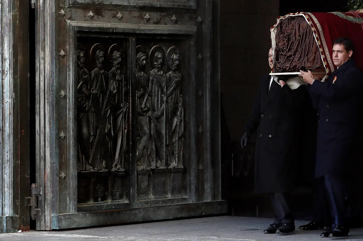 Family-members-including-Prince-Louis-Alphonse-of-Bourbon-Duke-of-Anjou-right-carry-the-coffin-of-Spanish-dictator-Francisco-Franco-out-of-the-basilica-of-the-Valle-de-los-Caidos-Valley-of-the-Fallen-mausoleum-in-San-Lorenzo-del-Escorial-on-Oct-24-2019-Spain-has-removed-the-remains-of-dictator-Francisco-Franco-from-a-grandiose-state-mausoleum-northwest-of-Madrid-today-The-long-awaited-date-was-announced-after-Spain-s-Supreme-Court-last-month-overruled-a-string-of-objections-from-his-family-who-had-tried-to-halt-the-exhumation-The-remains-will-be-relocated-to-Mingorrubio-El-Pardo-a-state-cemetery-20-kilometres-12-miles-north-of-the-capital-and-placed-next-to-those-of-his-wife-Carmen-Polo
