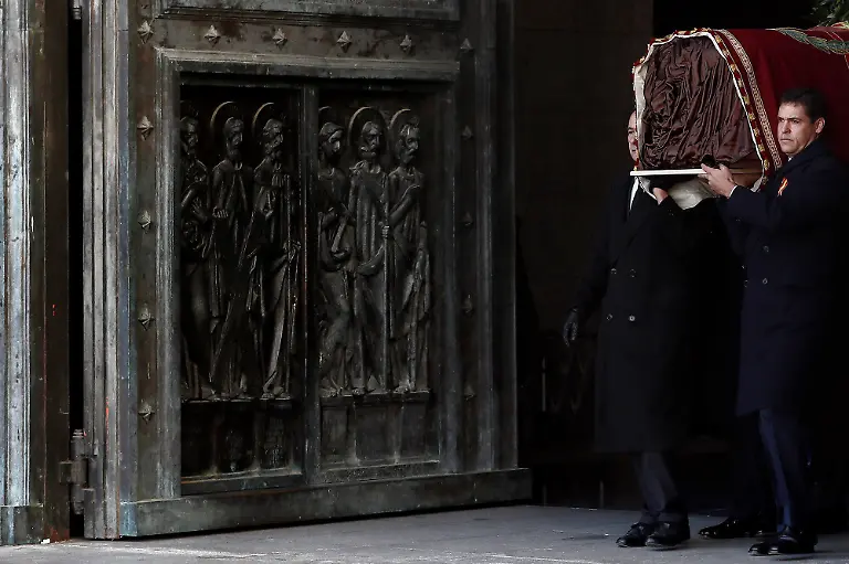 Family-members-including-Prince-Louis-Alphonse-of-Bourbon-Duke-of-Anjou-right-carry-the-coffin-of-Spanish-dictator-Francisco-Franco-out-of-the-basilica-of-the-Valle-de-los-Caidos-Valley-of-the-Fallen-mausoleum-in-San-Lorenzo-del-Escorial-on-Oct-24-2019-Spain-has-removed-the-remains-of-dictator-Francisco-Franco-from-a-grandiose-state-mausoleum-northwest-of-Madrid-today-The-long-awaited-date-was-announced-after-Spain-s-Supreme-Court-last-month-overruled-a-string-of-objections-from-his-family-who-had-tried-to-halt-the-exhumation-The-remains-will-be-relocated-to-Mingorrubio-El-Pardo-a-state-cemetery-20-kilometres-12-miles-north-of-the-capital-and-placed-next-to-those-of-his-wife-Carmen-Polo