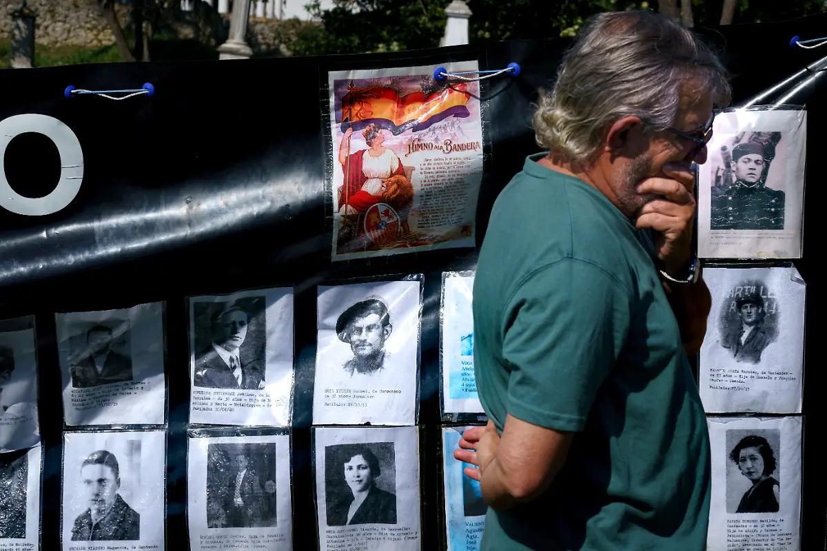 May-14-2024-Santander-Cantabria-Spain-A-man-surrounded-of-photos-of-civilians-killed-by-the-Franco-dictatorship-attends-the-anniversary-of-the-beginning-of-the-second-Spanish-Republic-in-the-main-cemetery-of-Santander-where-many-republicans-were-shot-and-buried-anonymously-in-common-graves