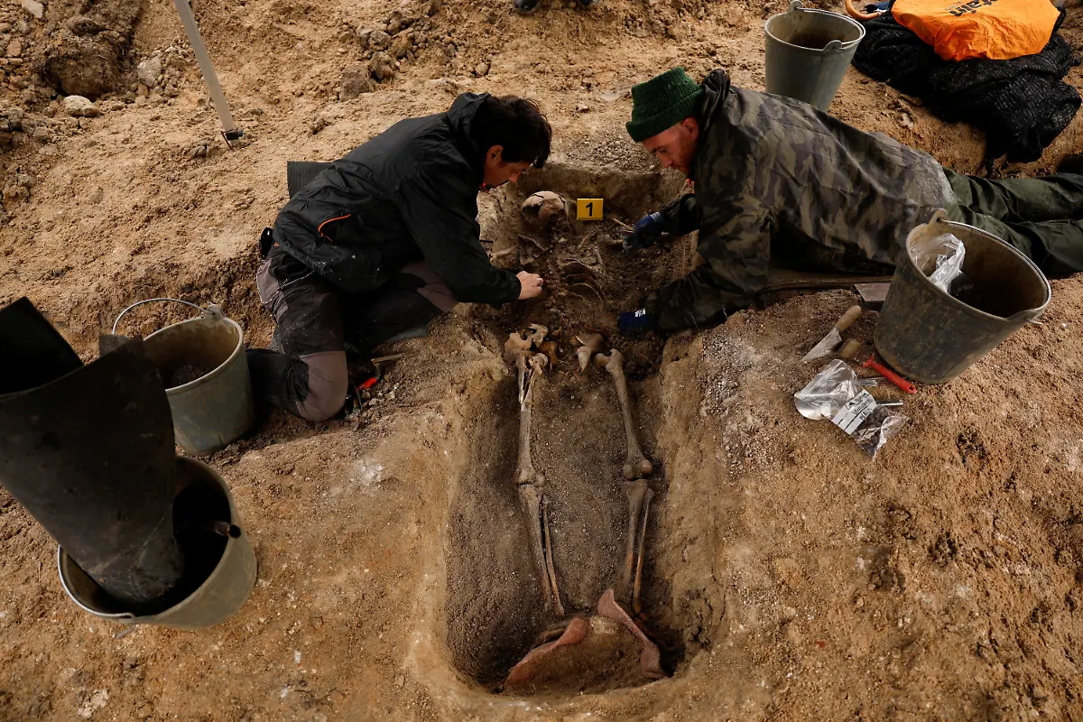 David-Ramirez-and-Serxio-Castro-members-of-the-Association-for-the-Recovery-of-Historical-Memory-ARMH-take-part-in-the-exhumation-of-a-mass-grave-of-one-of-the-two-victims-who-were-shot-in-1936-by-forces-of-Spanish-dictator-Francisco-Franco-near-Vegas-de-Matute-Spain-November-13-2025