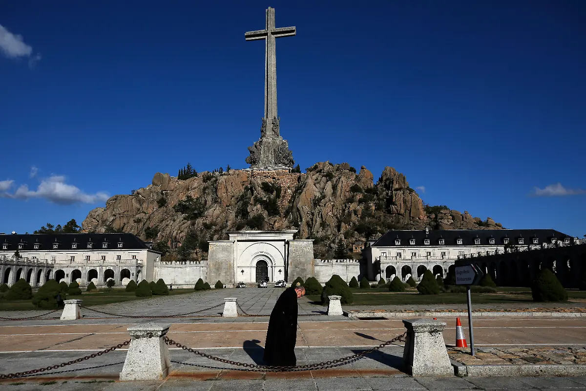 In-this-photo-taken-on-Sunday-Oct-13-2019-A-friar-walks-in-front-of-The-Valley-of-the-Fallen-mausoleum-near-El-Escorial-outskirts-of-Madrid-After-a-tortuous-judicial-and-public-relations-battle-Spain-s-Socialist-government-has-announced-that-Gen-Francisco-Franco-s-embalmed-body-will-be-relocated-from-a-controversial-shrine-to-a-small-public-cemetery-where-the-former-dictator-s-remains-will-lie-along-with-his-deceased-wife