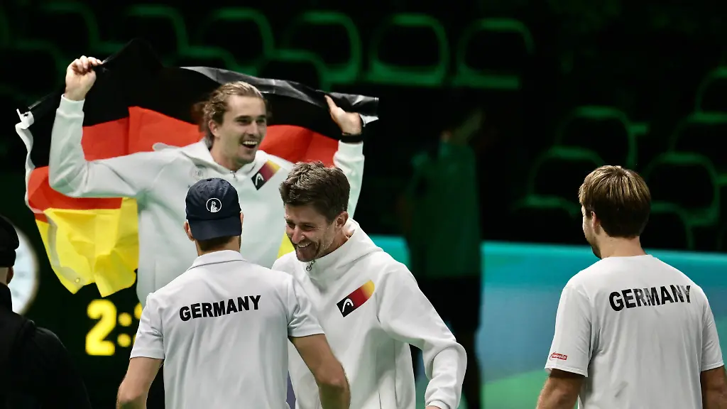 Germany-secured-a-21-victory-over-Argentina-in-the-Davis-Cup-quarterfinals-after-Tim-Puetz-and-Kevin-Krawietz-won-the-doubles-match-in-three-sets-The-images-show-Puetz-brown-hair-and-Krawietz-blonde-celebrating-alongside-Alexander-Zverev-holding-the-national-flag-with-Jan-Lennard-Struff-and-team-captain-Michael-Kohlmann-also-present-The-win-sends-Germany-into-the-Davis-Cup-semifinals-DELUCACEZARO-sipa