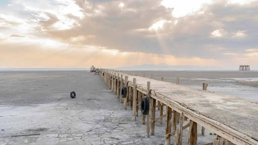 Remnants-of-a-wooden-pier-remain-on-the-dry-bed-of-Urmia-Lake-West-Azerbaijan-province-Iran-on-October-13-2024-Urmia-Lake-at-its-greatest-extent-was-the-largest-lake-in-the-Middle-East-Due-to-the-general-drought-in-Iran-and-the-construction-of-numerous-dams-on-the-rivers-that-feed-it-Urmia-Lake-fully-dried-up-in-2025