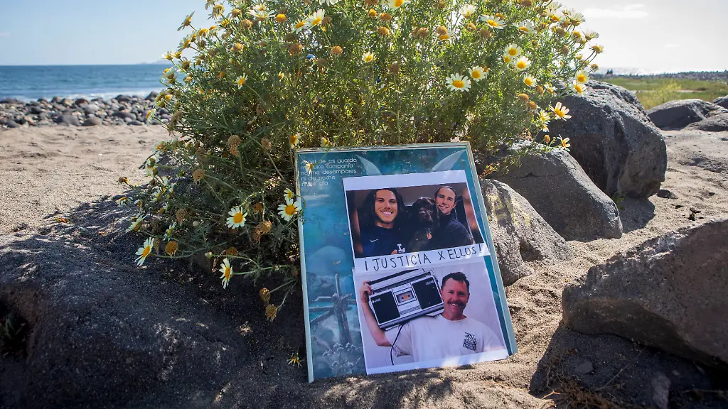 The-photos-of-the-foreign-surfers-who-disappeared-are-placed-on-the-beach-in-Ensenada-Mexico-Sunday-May-5-2024-Mexican-authorities-said-Friday-that-three-bodies-were-recovered-in-an-area-of-Baja-California-near-where-two-Australians-and-an-American-went-missing-last-weekend-during-an-apparent-camping-and-surfing-trip