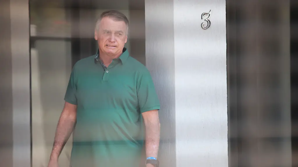 Brazil-s-former-President-Jair-Bolsonaro-stands-at-the-entrance-of-his-home-where-he-is-under-house-arrest-in-Brasilia-Brazil-Thursday-Sept-11-2025