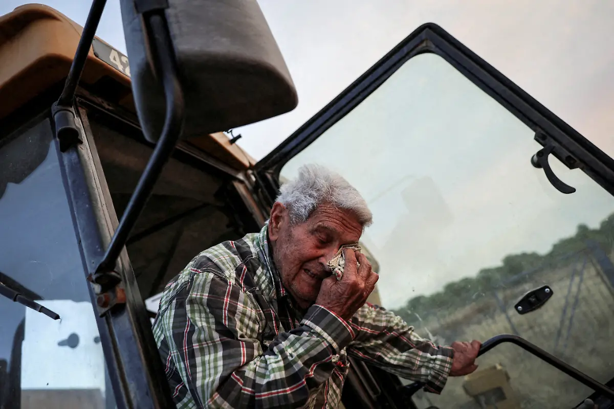 Paco-Amposta-90-reacts-as-he-opens-the-door-of-an-excavator-he-used-to-clear-the-field-around-his-house-in-front-of-a-wildfire-near-Xerta-Catalonia-Spain-July-8-2025-Although-the-record-breaking-wildfires-that-ripped-across-Spain-and-Portugal-in-August-have-subsided-residents-in-rural-communities-in-Spain-s-northwestern-Galicia-region-are-still-battling-the-aftermath-What-happened-here-is-crazy-said-Cristina-Santin-a-biologist-from-northwestern-Spain-who-studies-fire-impacts-Suddenly-you-get-up-one-day-and-your-home-region-is-burning-on-a-scale-that-is-completely-unprecedented-REUTERS-Nacho-Doce-SEARCH-IBERIA-WILDFIRES-AFTERMATH-FOR-THIS-STORY-SEARCH-WIDER-IMAGE-FOR-ALL-STORIES