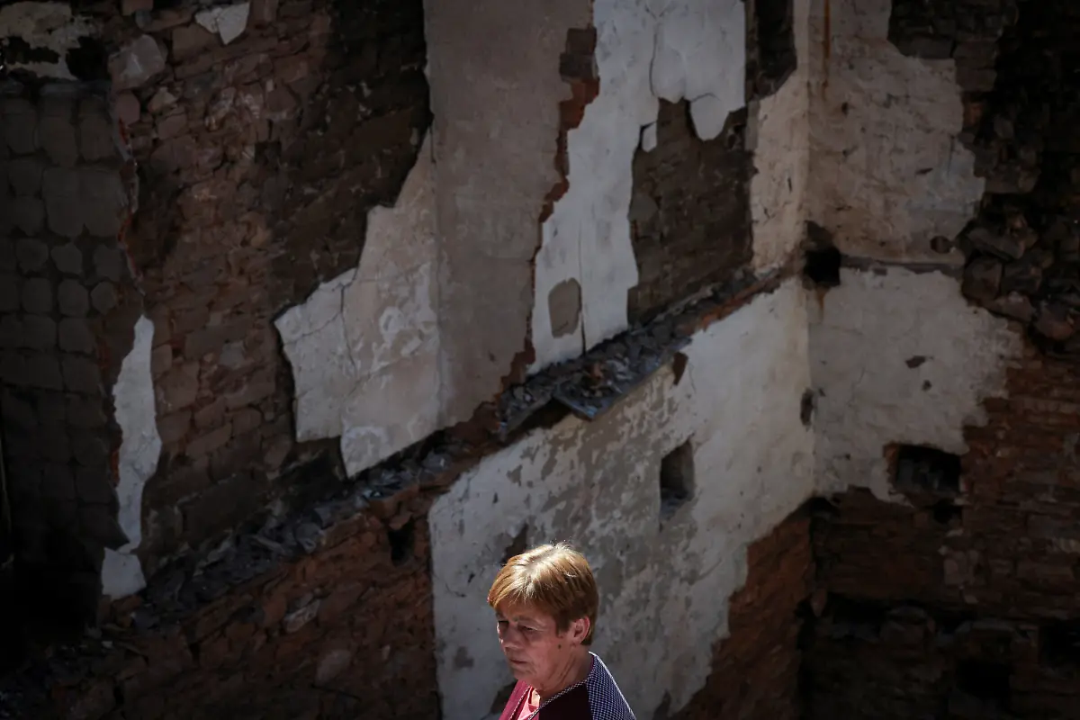 Ana-Sanchez-68-stands-in-silence-before-the-ruins-of-her-home-as-her-husband-Leopoldo-Nogueira-not-pictures-78-recounts-the-night-they-fled-while-a-wildfire-approached-eventually-destroying-their-house-and-the-entire-village-in-San-Vicente-de-Leira-Galicia-Spain-September-17-2025-Although-the-record-breaking-wildfires-that-ripped-across-Spain-and-Portugal-in-August-have-subsided-residents-in-rural-communities-in-Spain-s-northwestern-Galicia-region-are-still-battling-the-aftermath-The-flames-were-much-higher-than-the-pine-trees-they-were-approaching-at-an-incredible-speed-and-in-less-than-five-minutes-the-fire-was-close-by-At-that-moment-I-decided-to-leave-said-Nogueira-The-day-after-they-almost-passed-out-from-the-pain-of-seeing-this-REUTERS-Violeta-Santos-Moura-SEARCH-IBERIA-WILDFIRES-AFTERMATH-FOR-THIS-STORY-SEARCH-WIDER-IMAGE-FOR-ALL-STORIES