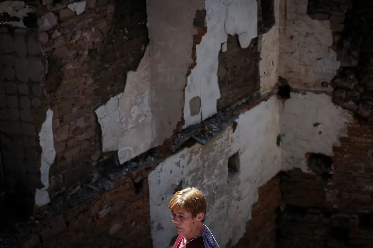 Ana-Sanchez-68-stands-in-silence-before-the-ruins-of-her-home-as-her-husband-Leopoldo-Nogueira-not-pictures-78-recounts-the-night-they-fled-while-a-wildfire-approached-eventually-destroying-their-house-and-the-entire-village-in-San-Vicente-de-Leira-Galicia-Spain-September-17-2025-Although-the-record-breaking-wildfires-that-ripped-across-Spain-and-Portugal-in-August-have-subsided-residents-in-rural-communities-in-Spain-s-northwestern-Galicia-region-are-still-battling-the-aftermath-The-flames-were-much-higher-than-the-pine-trees-they-were-approaching-at-an-incredible-speed-and-in-less-than-five-minutes-the-fire-was-close-by-At-that-moment-I-decided-to-leave-said-Nogueira-The-day-after-they-almost-passed-out-from-the-pain-of-seeing-this-REUTERS-Violeta-Santos-Moura-SEARCH-IBERIA-WILDFIRES-AFTERMATH-FOR-THIS-STORY-SEARCH-WIDER-IMAGE-FOR-ALL-STORIES
