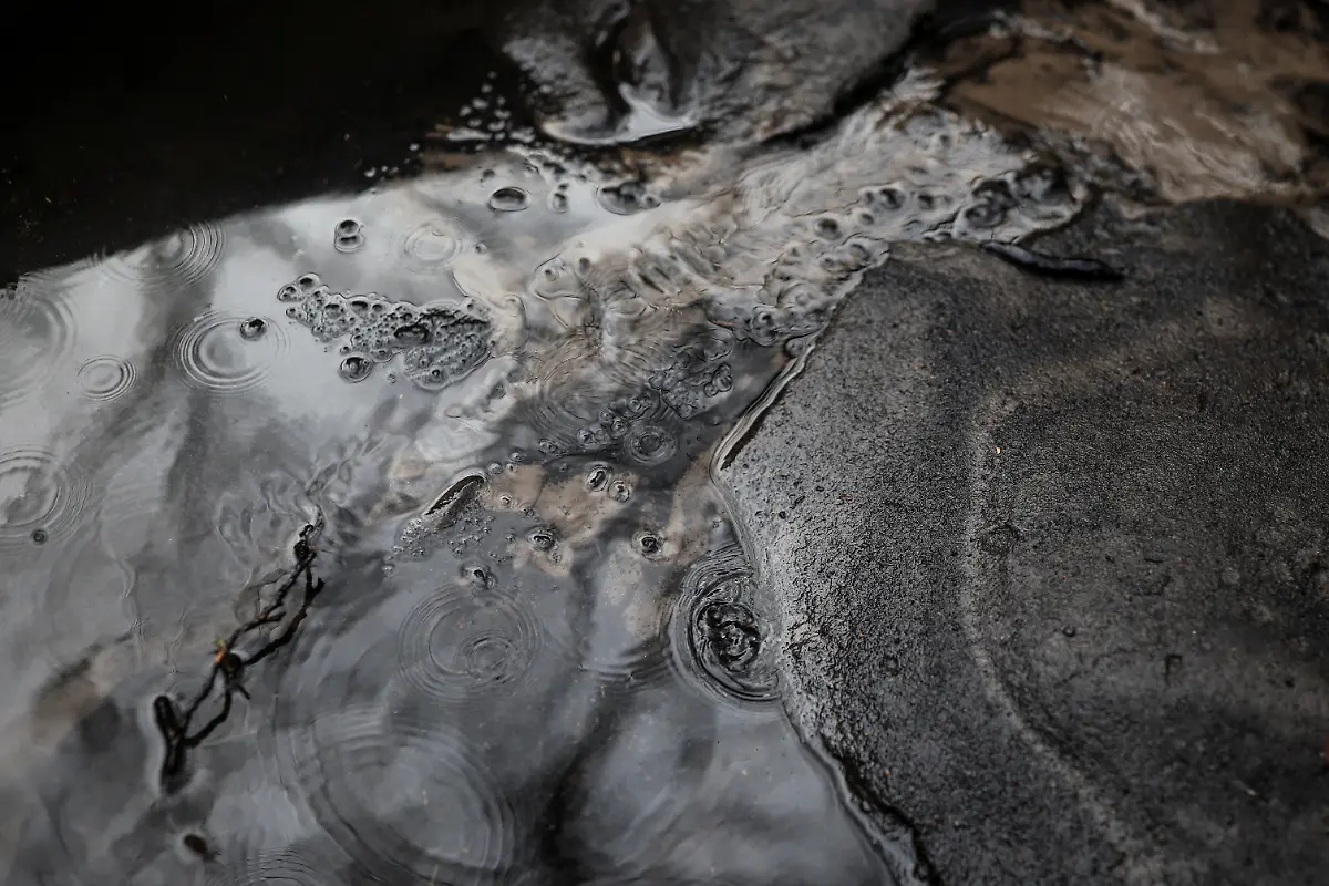 Ash-and-mud-dragged-by-seasonal-rains-is-pictured-inside-a-sandtrap-or-arenero-which-decants-rainwater-to-prevent-debris-from-reaching-the-water-line-after-a-wildfire-in-August-in-the-mountain-range-of-Serra-do-Larouco-Galicia-Spain-November-7-2025-As-the-seasonal-October-rains-picked-up-the-entire-vegetative-layer-which-had-turned-to-ash-began-to-clog-the-sandtraps-known-locally-as-areneros-that-decant-rainwater-to-prevent-debris-from-reaching-the-water-line-feeding-the-reservoir-We-have-been-here-for-almost-a-month-working-to-remove-the-ash-mixed-with-mud-said-Raul-Lopez-a-worker-for-the-municipality-We-have-never-seen-a-disaster-like-this-before-in-our-lives-Neither-my-grandfather-nor-my-father-nor-anyone-else-can-remember-a-disaster-like-this-REUTERS-Nacho-Doce-SEARCH-IBERIA-WILDFIRES-AFTERMATH-FOR-THIS-STORY-SEARCH-WIDER-IMAGE-FOR-ALL-STORIES