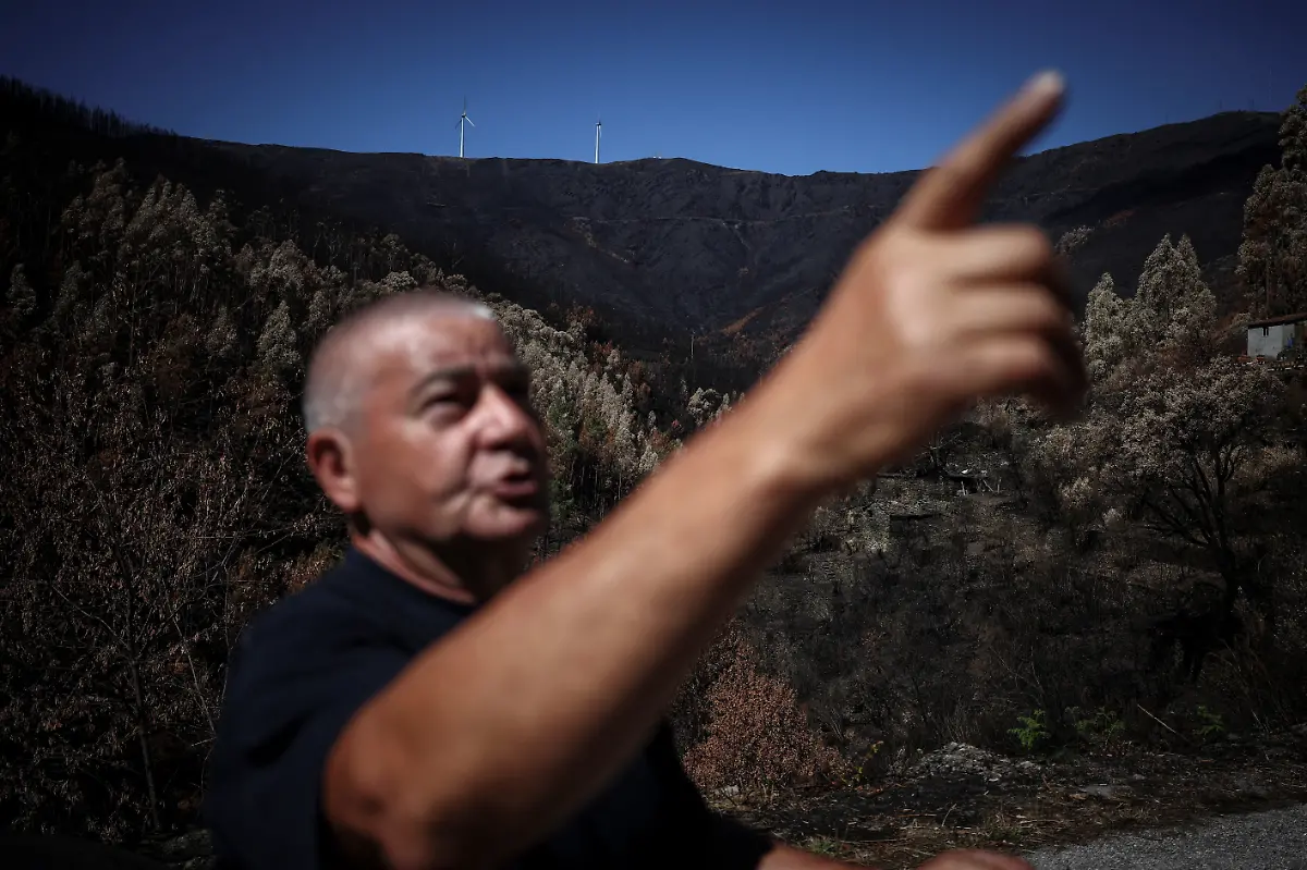 Antonio-Fontinha-a-retiree-who-lost-multiple-beehives-during-a-wildfire-talks-to-a-Reuters-journalist-near-Arganil-Portugal-September-11-2025-Although-the-record-breaking-wildfires-that-ripped-across-Spain-and-Portugal-in-August-have-subsided-residents-in-rural-communities-in-Spain-s-northwestern-Galicia-region-are-still-battling-the-aftermath-Spain-s-COAG-national-farmers-association-estimated-that-the-fires-had-caused-at-least-600-million-euros-699-72-million-in-damages-devastating-crops-and-buildings-and-leaving-livestock-dead-in-the-fields-REUTERS-Pedro-Nunes-SEARCH-IBERIA-WILDFIRES-AFTERMATH-FOR-THIS-STORY-SEARCH-WIDER-IMAGE-FOR-ALL-STORIES
