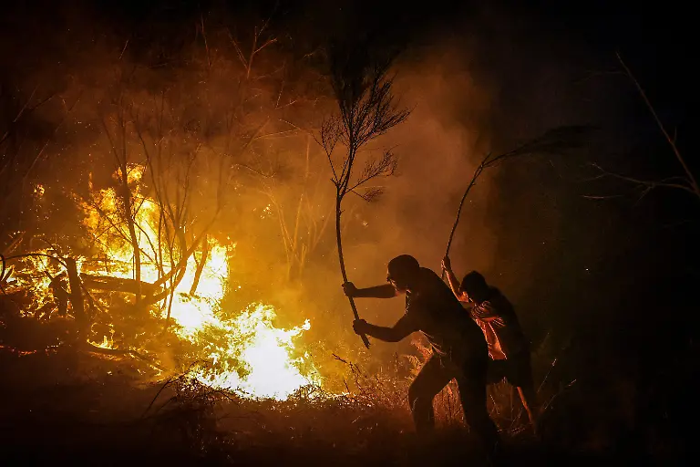 Residents-use-tree-branches-as-they-try-to-extinguish-flames-from-a-wildfire-in-Vilar-de-Condes-in-the-province-of-Ourense-in-Galicia-Spain-August-15-2025-Although-the-record-breaking-wildfires-that-ripped-across-Spain-and-Portugal-in-August-have-subsided-residents-in-rural-communities-in-Spain-s-northwestern-Galicia-region-are-still-battling-the-aftermath-What-happened-here-is-crazy-said-Cristina-Santin-a-biologist-from-northwestern-Spain-who-studies-fire-impacts-Suddenly-you-get-up-one-day-and-your-home-region-is-burning-on-a-scale-that-is-completely-unprecedented-REUTERS-Nacho-Doce-SEARCH-IBERIA-WILDFIRES-AFTERMATH-FOR-THIS-STORY-SEARCH-WIDER-IMAGE-FOR-ALL-STORIES
