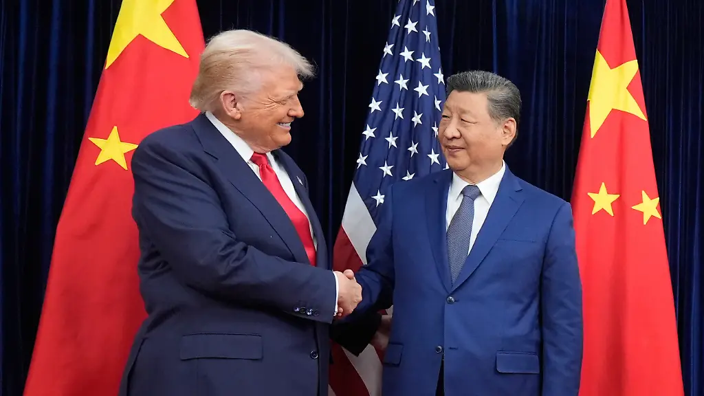 President-Donald-Trump-left-and-Chinese-President-Xi-Jinping-second-left-shake-hands-before-their-meeting-at-Gimhae-International-Airport-in-Busan-South-Korea-Thursday-Oct-30-2025