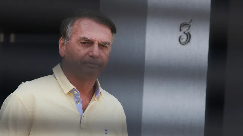 Brazil-s-former-President-Jair-Bolsonaro-stands-behind-the-entrance-gate-of-his-home-where-he-is-under-house-arrest-in-Brasilia-Brazil-Wednesday-Sept-3-2025