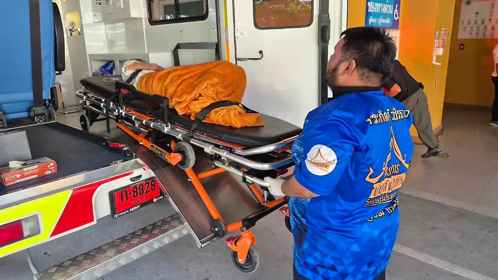 In-this-Sunday-Nov-23-2025-photo-an-emergency-rescue-team-transports-an-elderly-woman-discovered-to-still-be-alive-after-being-considered-deceased-to-a-local-hospital-before-her-scheduled-cremation-at-Wat-Rat-Prakhong-Tham-temple-Nonthaburi-province-Thailand