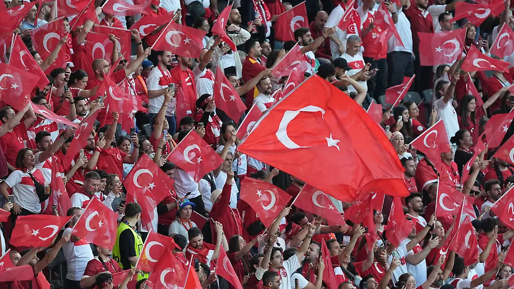 Netherlands-v-Turkiye-Quarter-Final-UEFA-EURO-EM-Europameisterschaft-Fussball-2024-BERLIN-GERMANY-JULY-06-Football-fans-of-Turkiye-hold-Turkish-flags-as-they-show-support-ahead-of-the-UEFA-EURO-2024-Quarter-Final-football-match-between-Netherlands-and-Turkiye-at-Olympiastadion-in-Berlin-Germany-on-July-06-2024-Germany-World-Editorial-use-only-Please-get-in-touch-for-any-other-usage