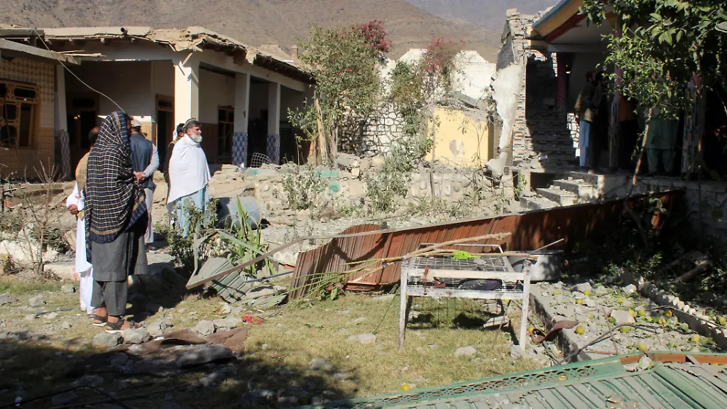 People-stand-in-front-of-damaged-houses-that-the-Afghan-Taliban-government-said-were-damaged-after-Pakistan-carried-out-raids-in-Asadabad-Kunar-province-Afghanistan-November-25-2025