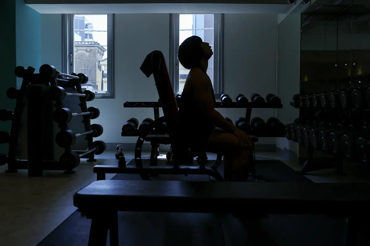 Hitomi-Harigae-38-manager-of-Muscle-Girls-a-fitness-themed-bar-pauses-while-doing-weight-training-at-Muscle-gym-in-Tokyo-Japan-August-4-2025-Female-bodybuilding-has-gained-popularity-in-Japan-in-recent-years-with-competitions-held-in-many-cities-But-outside-that-circle-the-old-conventions-rule-Harigae-said-REUTERS-Kim-Kyung-Hoon-SEARCH-KYUNG-HOON-MUSCLE-GIRLS-FOR-THIS-STORY-SEARCH-WIDER-IMAGE-FOR-ALL-STORIES