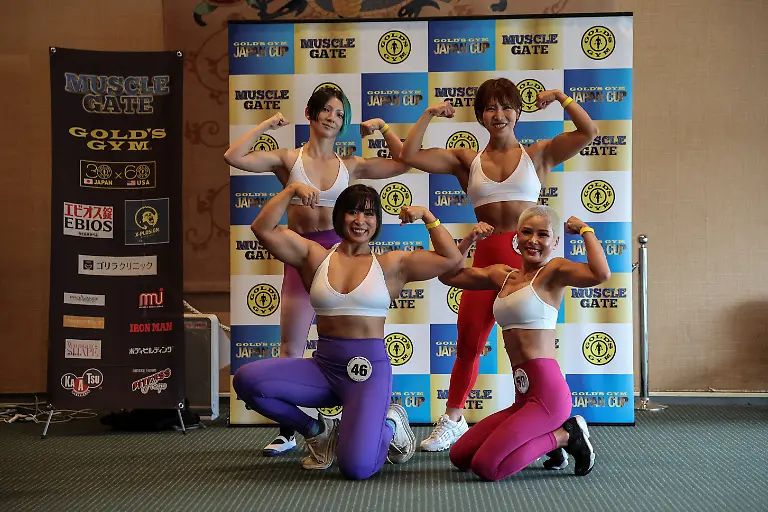 Miwako-Yokoyama-40-Eri-Maeda-28-Hitomi-Harigae-38-and-Nozomi-Nakamura-38-staffers-at-Muscle-Girls-a-fitness-themed-bar-in-Tokyo-pose-for-a-photo-after-participating-in-the-regional-competition-of-Muscle-Gate-a-bodybuilding-tournament-in-Saitama-Japan-October-11-2025-Female-bodybuilding-has-gained-popularity-in-Japan-in-recent-years-with-competitions-held-in-many-cities-But-outside-that-circle-the-old-conventions-rule-Harigae-said-REUTERS-Kim-Kyung-Hoon-SEARCH-KYUNG-HOON-MUSCLE-GIRLS-FOR-THIS-STORY-SEARCH-WIDER-IMAGE-FOR-ALL-STORIES