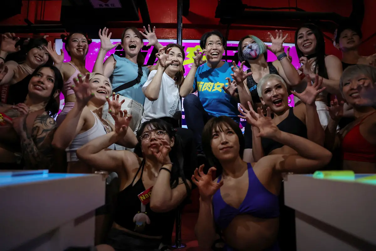 Staffers-at-Muscle-Girls-a-fitness-themed-bar-pose-for-a-photo-with-female-customers-in-Tokyo-Japan-July-25-2025-At-Muscle-Girls-Japan-s-only-female-fitness-themed-bar-about-30-young-women-passionate-about-workouts-and-bodybuilding-entertain-customers-and-flaunt-their-brawny-physiques-REUTERS-Kim-Kyung-Hoon-SEARCH-KYUNG-HOON-MUSCLE-GIRLS-FOR-THIS-STORY-SEARCH-WIDER-IMAGE-FOR-ALL-STORIES