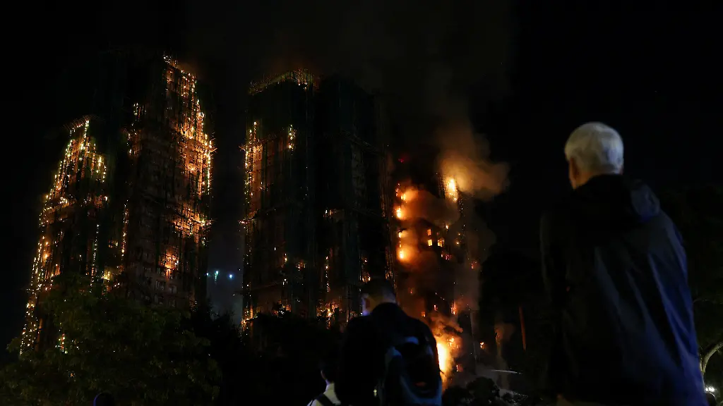 People-watch-as-flames-burn-bamboo-scaffolding-across-multiple-buildings-at-Wang-Fuk-Court-housing-estate-in-Tai-Po-Hong-Kong-China-November-26-2025