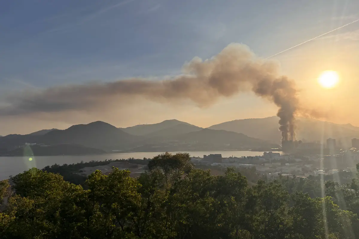 Fire-engulfs-high-rise-subsidised-sale-public-housing-in-Tai-Po-View-from-Tai-Po-Industrial-Estate-showing-fire-spread-across-the-exterior-scaffolding-reaching-halfway-into-the-air-and-blowing-towards-the-Tolo-Harbour-area-on-November-26-2025-in-Hong-Kong
