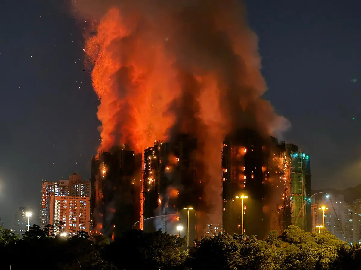 Thick-smoke-and-flames-rise-as-a-major-fire-engulfs-several-apartment-blocks-at-the-Wang-Fuk-Court-residential-estate-in-Hong-Kong-s-Tai-Po-district-on-November-26-2025-At-least-four-people-were-killed-when-a-fire-engulfed-several-high-rise-blocks-in-a-Hong-Kong-residential-estate-on-November-26-the-government-said-with-media-reporting-that-some-residents-were-trapped-inside