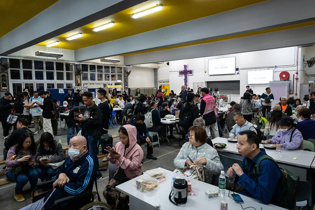 Residents-rest-at-a-temporary-shelter-after-a-fire-broke-out-at-Wang-Fuk-Court-a-residential-estate-in-the-Tai-Po-district-of-Hong-Kong-s-New-Territories-Wednesday-Nov-26-2025