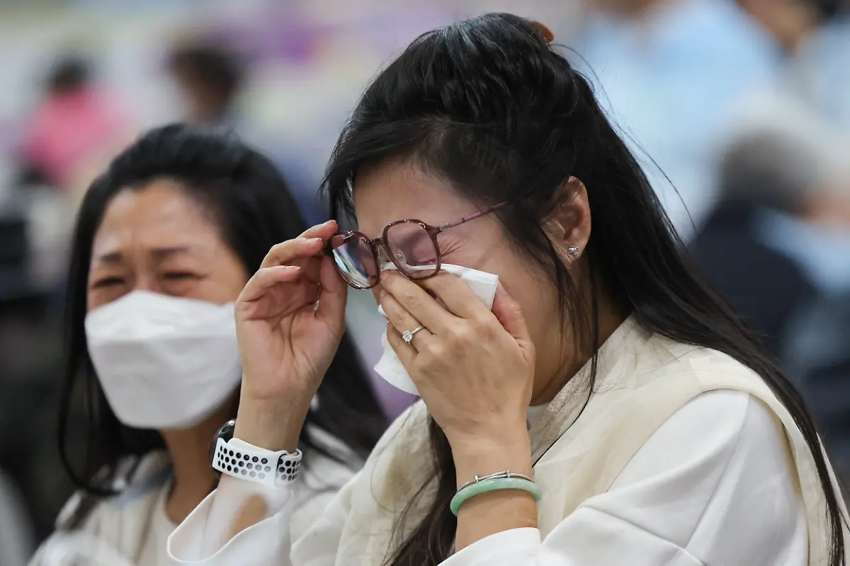 A-woman-reacts-at-a-temporary-shelter-after-a-fire-started-across-multiple-buildings-at-Wang-Fuk-Court-housing-estate-in-Tai-Po-Hong-Kong-China-November-26-2025