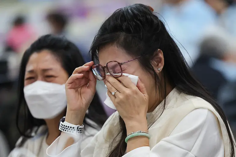 A-woman-reacts-at-a-temporary-shelter-after-a-fire-started-across-multiple-buildings-at-Wang-Fuk-Court-housing-estate-in-Tai-Po-Hong-Kong-China-November-26-2025