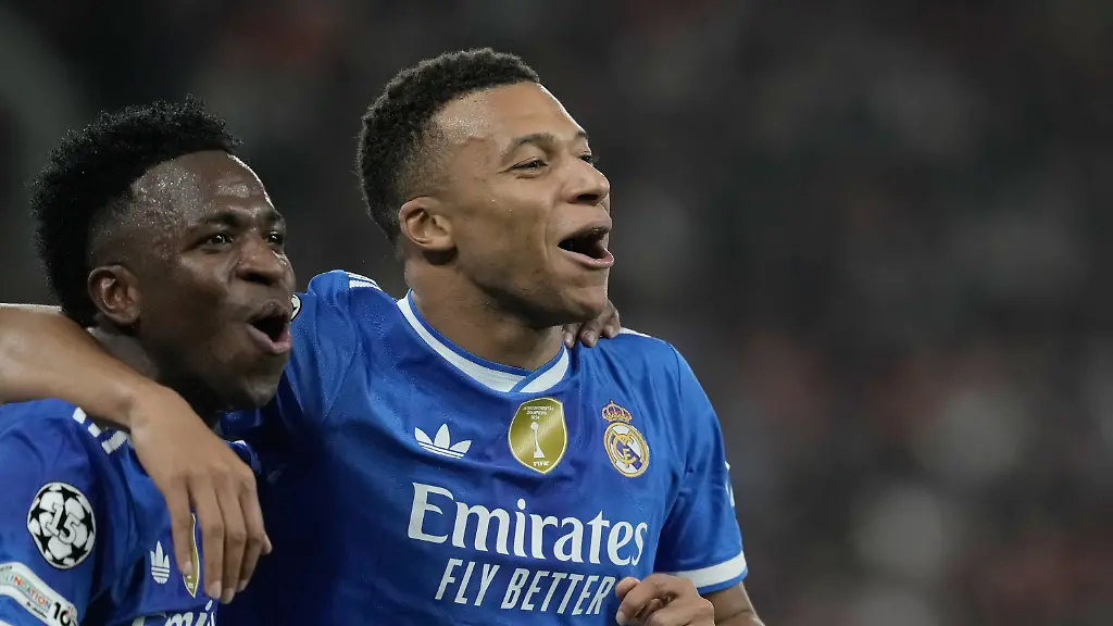 Real-Madrid-s-Kylian-Mbappe-right-celebrates-with-his-teammate-Vinicius-Junior-after-scoring-his-side-s-fourth-goal-during-the-Champions-League-opening-phase-soccer-match-between-Olympiacos-and-Real-Madrid-in-in-Piraeus-port-near-Athens-Greece-Wednesday-Nov-26-2025