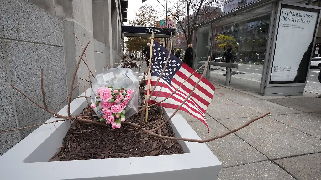 Flowers-and-an-American-flag-are-seen-on-Thursday-November-27-at-the-scene-where-two-West-Virginia-National-Guard-members-were-shot-near-the-White-House-in-downtown-Washington-DC-on-November-26-2025-An-Afghan-national-who-worked-with-the-CIA-in-his-native-country-has-been-arrested-in-connection-with-the-November-26-shooting