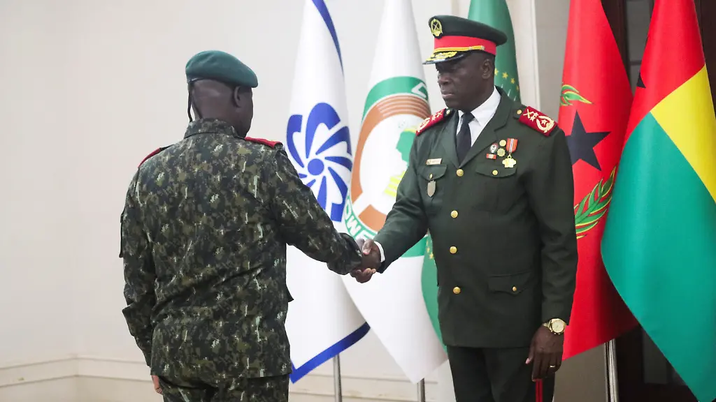 Major-General-Horta-Inta-a-the-new-transitional-president-shakes-hands-with-Major-General-Tomas-Djassi-during-Djassi-s-swearing-in-ceremony-as-the-new-chief-of-staff-of-the-Armed-Forces-in-Bissau-Guinea-Bissau-November-27-2025