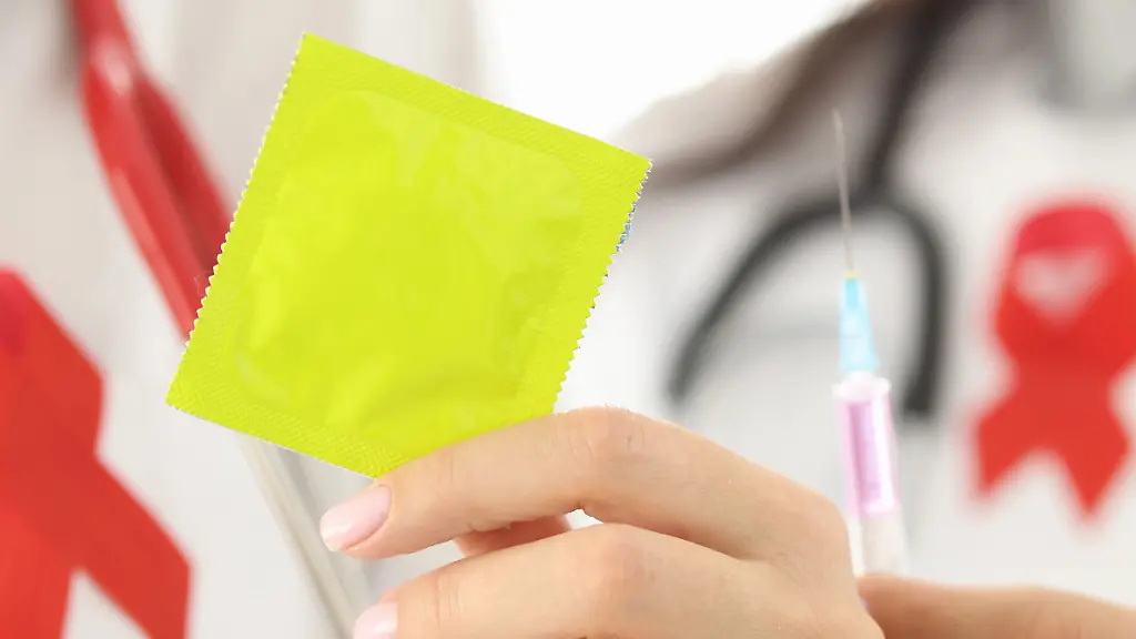 Female-doctors-are-holding-condom-and-syringe-with-needle