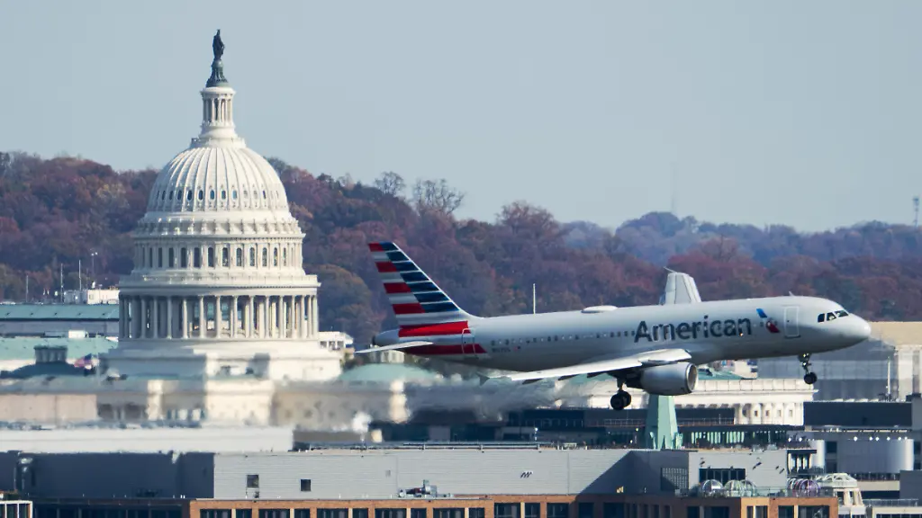 UNITED-STATES-NOVEMBER-7-An-American-Airlines-Airbus-A320-plane-passes-by-the-U-S-Capitol-dome-in-Washington-as-it-comes-in-for-a-landing-at-Ronald-Reagan-Washington-National-Airport-on-Friday-November-7-2025-Starting-today-the-Federal-Aviation-Administration-forced-airlines-to-cut-10-of-flights-at-40-busy-airports-including-Washington-National-to-reduce-the-load-on-air-traffic-controllers-during-the-government-shutdown