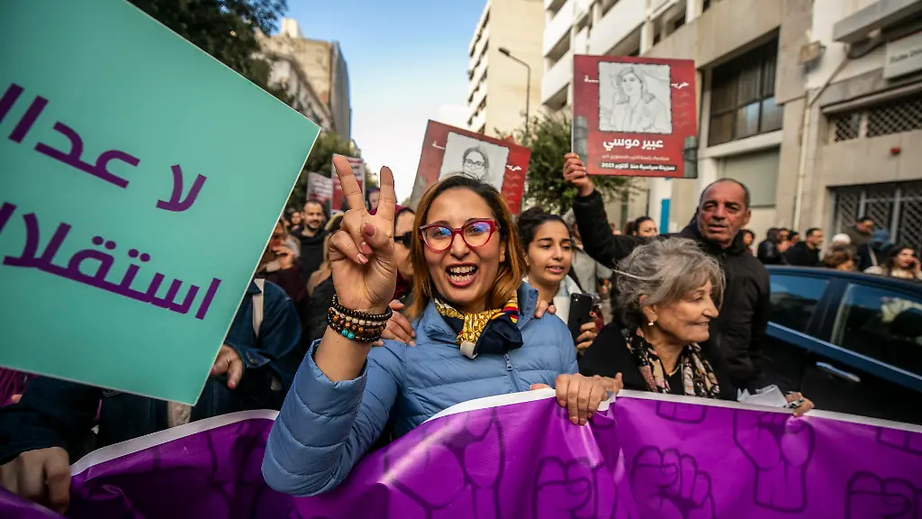 Protesters-marched-from-Place-Pasteur-toward-Avenue-Habib-Bourguiba-on-November-29-2025-in-Tunis-Tunisia-carrying-Tunisian-flags-placards-denouncing-authoritarian-rule-and-political-prosecutions-and-photos-of-political-detainees-Among-them-was-Chaima-Issa-a-prominent-defendant-in-the-so-called-conspiracy-case-who-took-part-in-the-early-phase-of-the-march-before-being-arrested-prior-to-its-conclusion-The-protest-followed-new-verdicts-issued-in-the-same-case-as-demonstrators-warned-against-concentrated-power-restrictions-on-civil-society-and-escalating-political-trials
