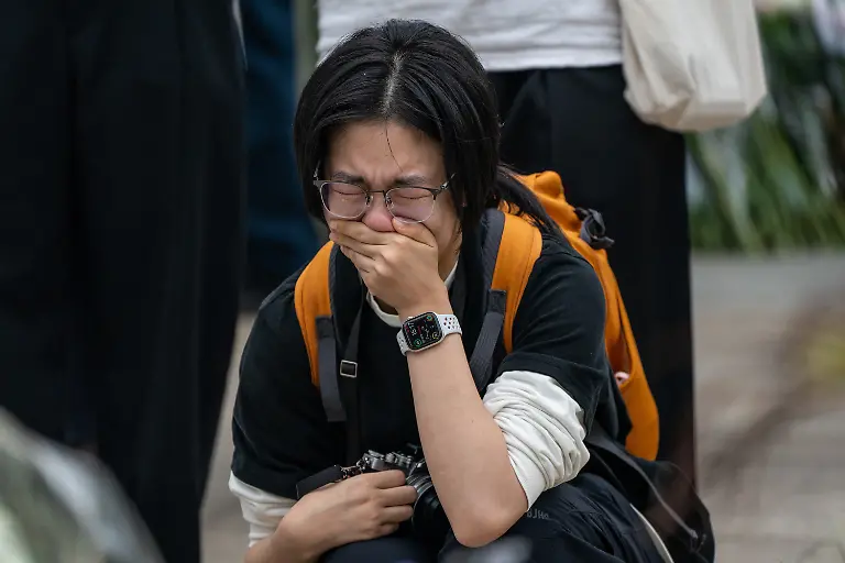 November-30-2025-Hong-Kong-Hong-Kong-A-mourner-reacts-at-a-makeshift-memorial-near-Wang-Fuk-Court-housing-complex-in-Tai-Po-following-a-deadly-fire-on-November-30-2025-in-Hong-Kong