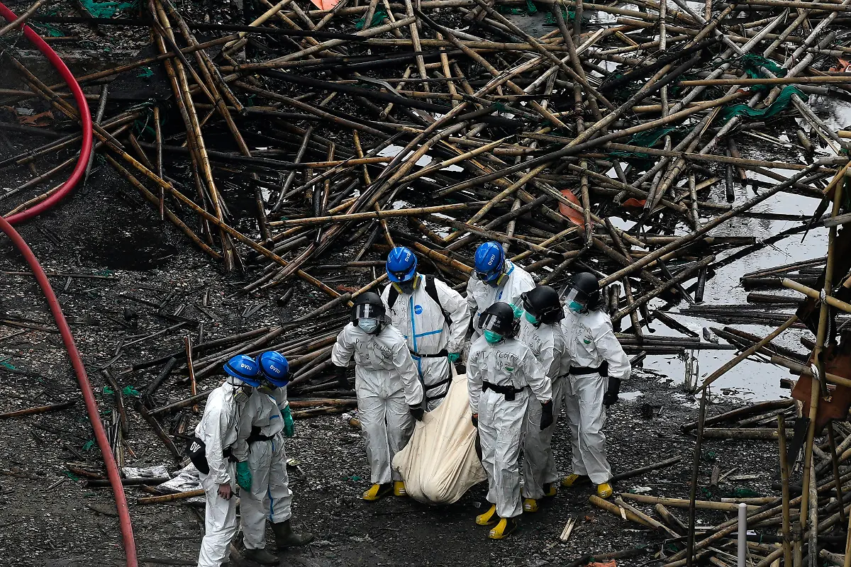 Emergency-crew-remove-what-appears-to-be-a-body-bag-from-the-site-of-a-deadly-Wednesday-fire-at-Wang-Fuk-Court-a-residential-estate-in-the-Tai-Po-district-of-Hong-Kong-s-New-Territories-on-Sunday-Nov-30-2025