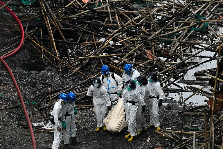 Emergency-crew-remove-what-appears-to-be-a-body-bag-from-the-site-of-a-deadly-Wednesday-fire-at-Wang-Fuk-Court-a-residential-estate-in-the-Tai-Po-district-of-Hong-Kong-s-New-Territories-on-Sunday-Nov-30-2025