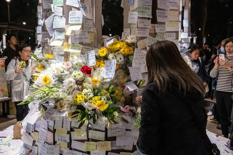 A-mourner-at-a-makeshift-memorial-near-Wang-Fuk-Court-housing-complex-in-Tai-Po-following-a-deadly-fire-on-November-30-2025-in-Hong-Kong