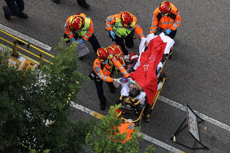 An-injured-resident-is-carried-into-an-ambulance-after-a-major-fire-engulfed-bamboo-scaffolding-across-multiple-blocks-at-Wang-Fuk-Court-housing-estate-killing-at-least-44-people-and-leaving-almost-300-missing-in-Tai-Po-Hong-Kong-China-November-27-2025