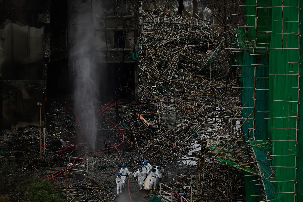 Emergency-crew-remove-what-appears-to-be-a-body-bag-from-the-site-of-a-deadly-Wednesday-fire-at-Wang-Fuk-Court-a-residential-estate-in-the-Tai-Po-district-of-Hong-Kong-s-New-Territories-on-Sunday-Nov-30-2025