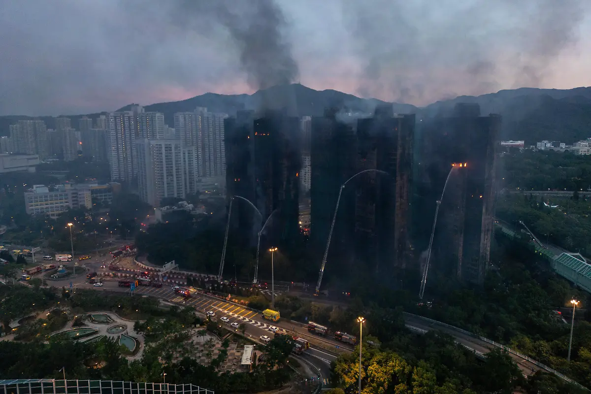 An-aerial-photograph-showing-Smoke-and-flames-rise-as-a-major-fire-engulfs-several-residential-buildings-at-Wang-Fuk-Court-on-November-27-2025-in-Hong-Kong-Serval-residential-building-in-Wang-Fuk-Court-located-in-Tai-Po-District-caught-fire-today-the-Hong-Kong-Fire-Department-has-issued-the-No-5-fire-alarm-the-fire-at-local-time-0500-44-Dead