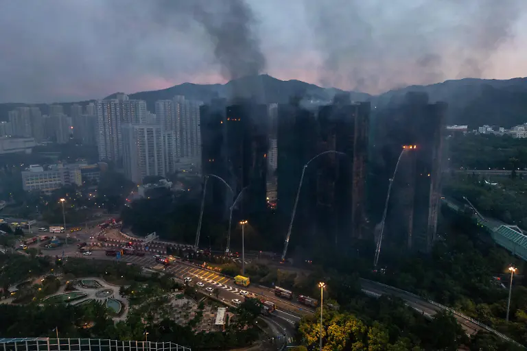 An-aerial-photograph-showing-Smoke-and-flames-rise-as-a-major-fire-engulfs-several-residential-buildings-at-Wang-Fuk-Court-on-November-27-2025-in-Hong-Kong-Serval-residential-building-in-Wang-Fuk-Court-located-in-Tai-Po-District-caught-fire-today-the-Hong-Kong-Fire-Department-has-issued-the-No-5-fire-alarm-the-fire-at-local-time-0500-44-Dead